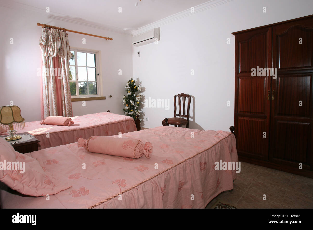 Luxury five star hotel bedroom in pink with twin beds Stock Photo