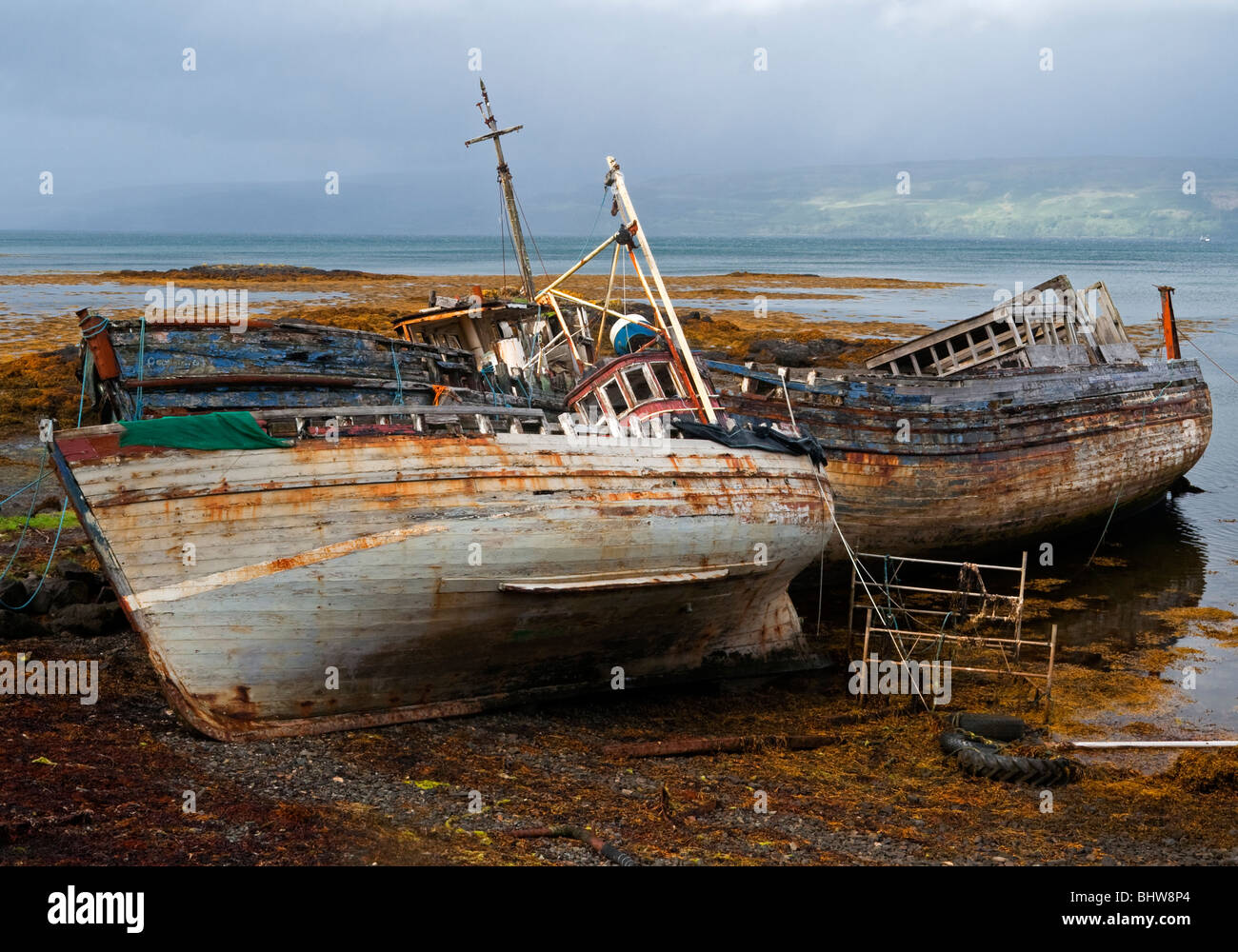 Shipwrecked decommissioned inshore fishing boats on the beach at Salen near  Tobermory Isle of Mull Inner Hebrides Scotland UK Stock Photo