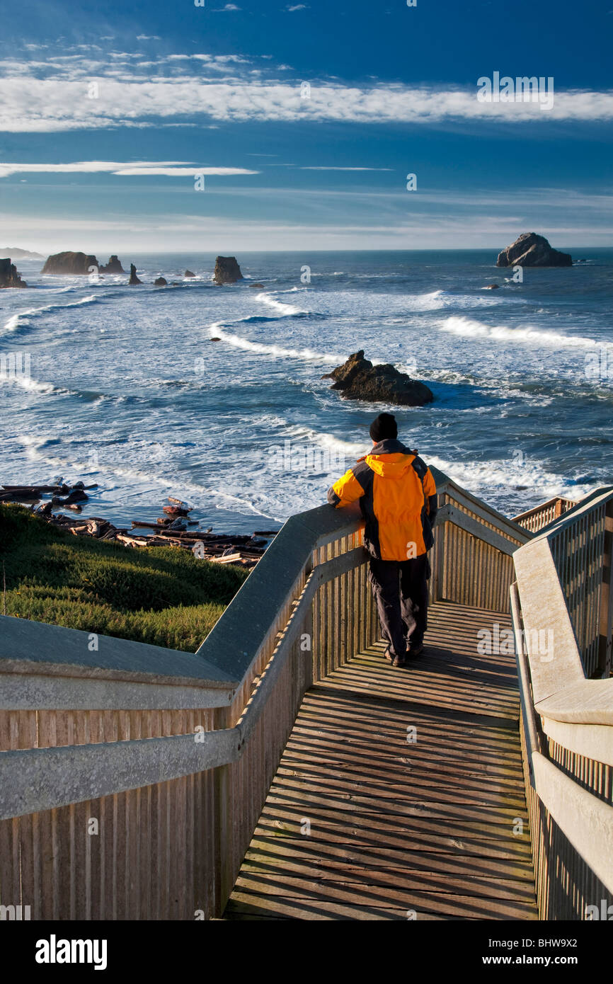 Tourist viewing ocean on stairs leading to beach at Bandon, Oregon. Stock Photo