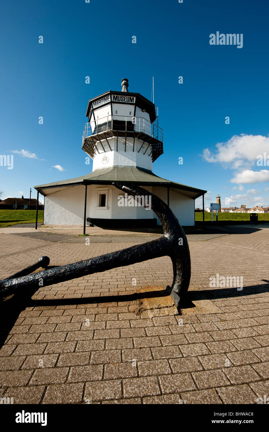 The Low Lighthouse with anchor at the port of Harwich, Essex, UK. Built in 1818 it is now home to the Maritime Museum. Stock Photo