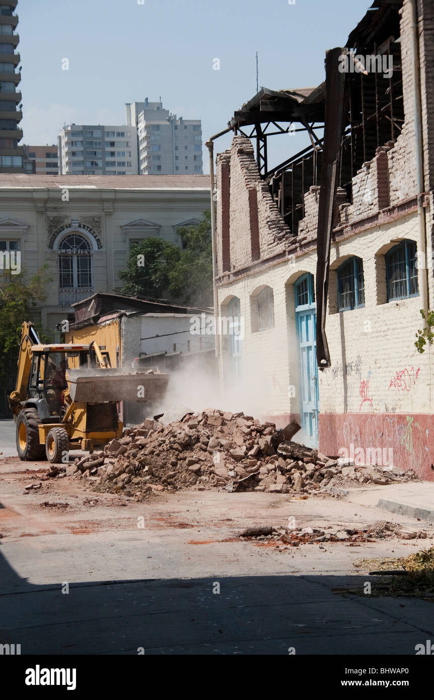 A Bucket Loader cleaning the debris of a collapsed wall Stock Photo - Alamy