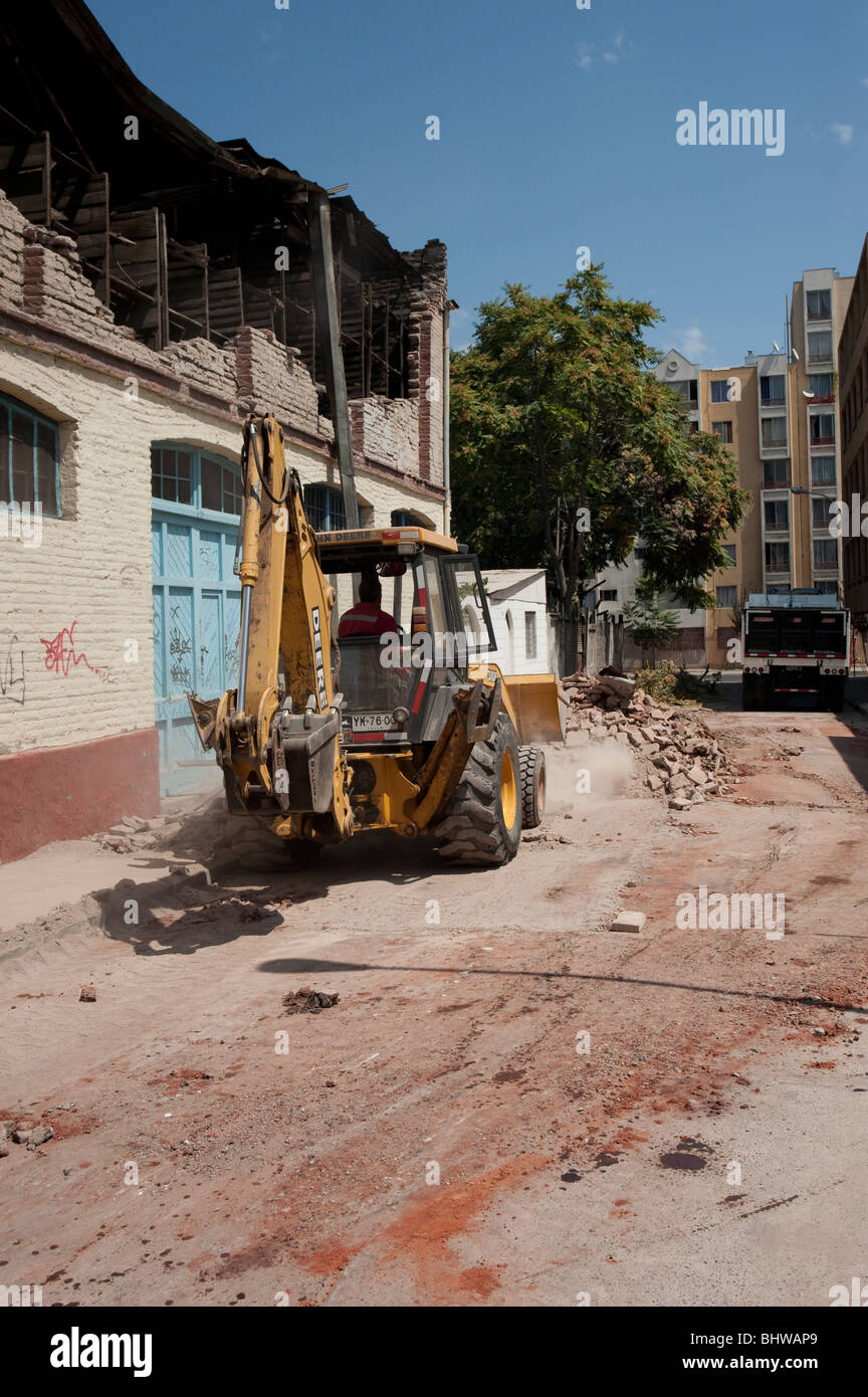 A Bucket Loader cleaning the debris of a collapsed wall Stock Photo - Alamy