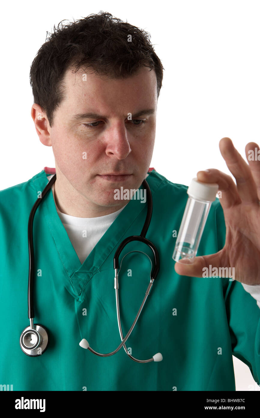 man wearing medical scrubs looking at empty specimen bottle Stock Photo