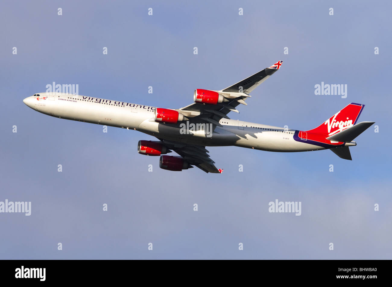 Airbus A340 operated by Virgin Atlantic climbing out from take off at London Heathrow Airport Stock Photo