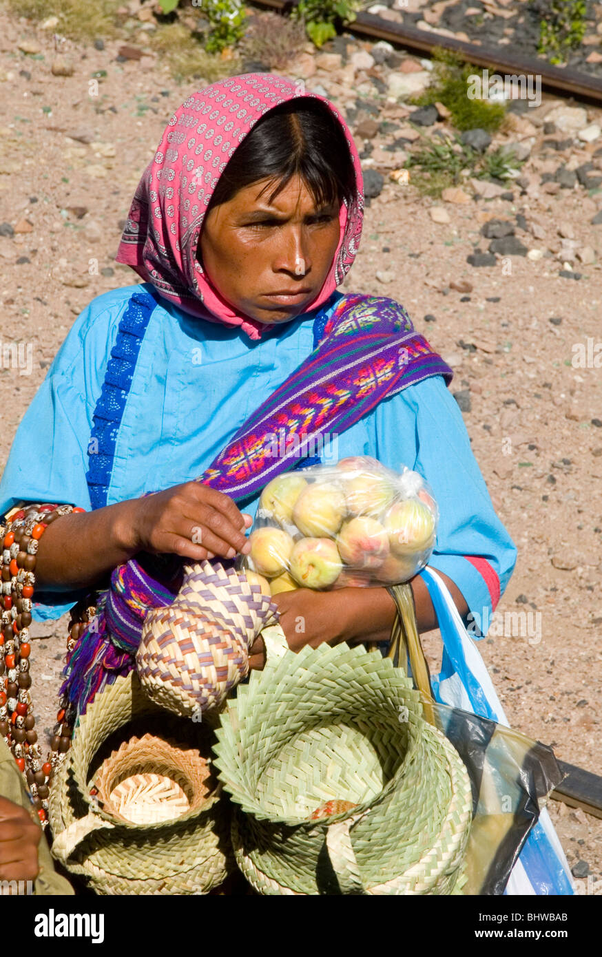 Copper Canyon Tarahumara woman sells woven baskets in Chihuahua State Mexico. Stock Photo