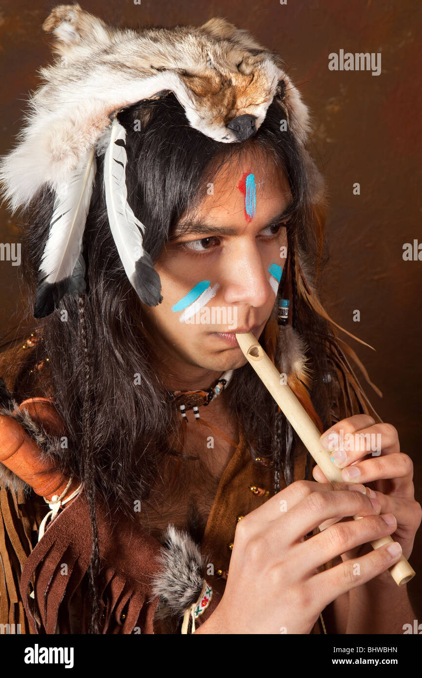 Portrait of an Indian in traditional costume wearing eagle feathers
