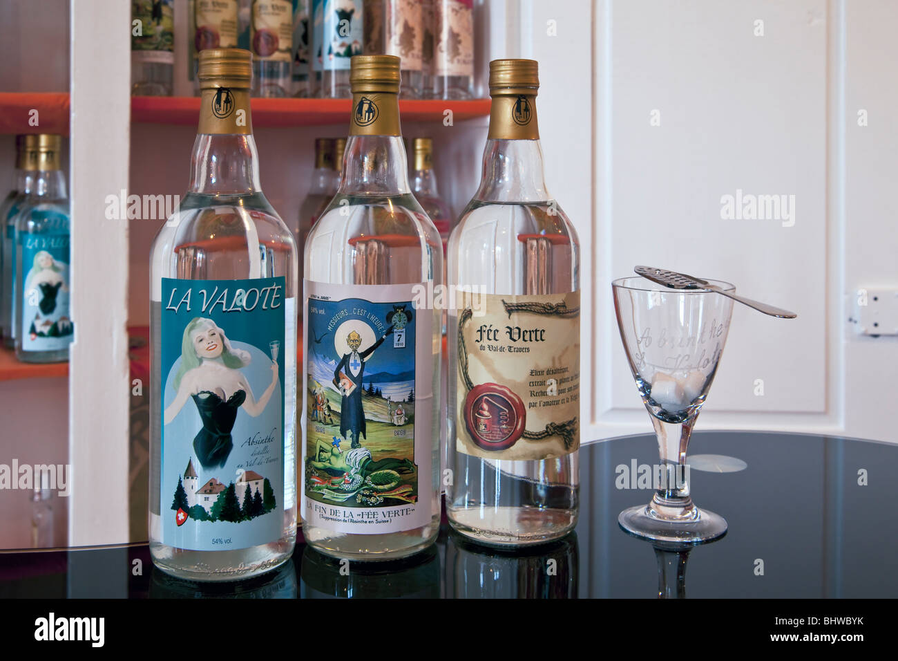 Bottles of absinthe with glass, spoon and sugar on display at the ...