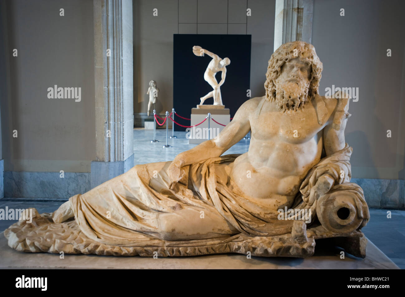 Statue of Oceanus, 2nd century AD, Ephesus, and disc thrower behind, Istanbul Archaeology Museum Turkey. Stock Photo