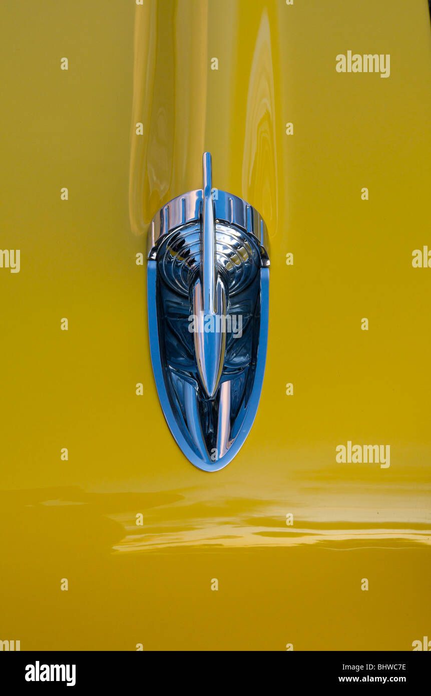 Bright yellow and chrome classic car hood ornament Stock Photo Alamy