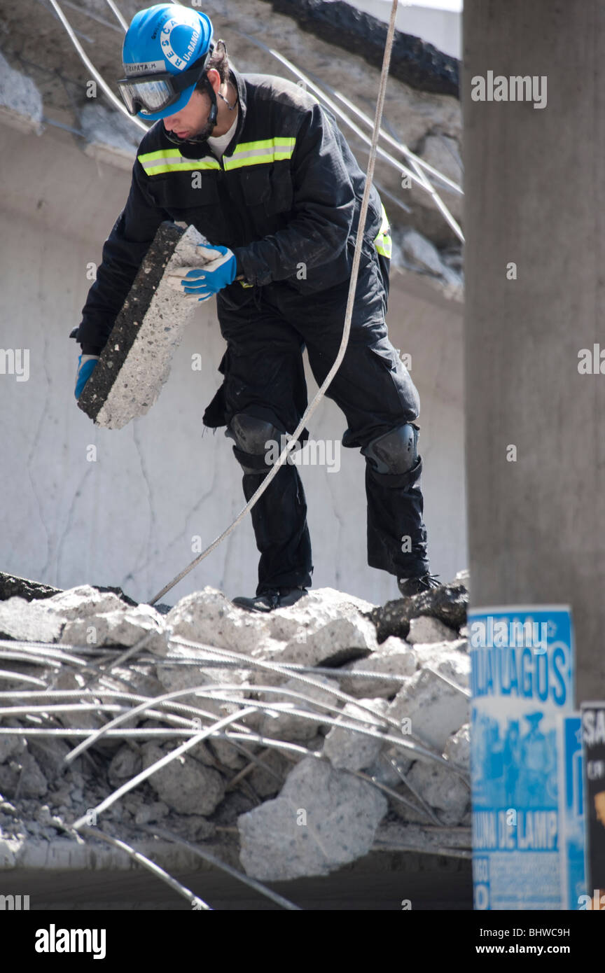 A Firemen Climbing on the ruins of the collapsed Highway, Americo Vespucio Norte. Stock Photo