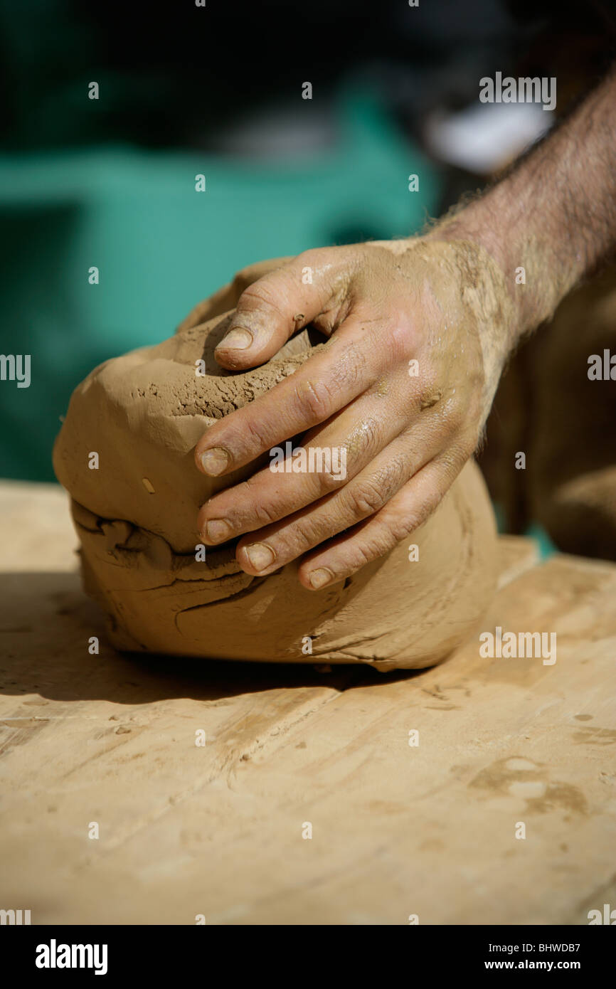 Hands moulding clay Stock Photo - Alamy