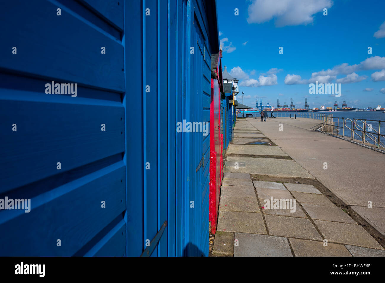 Beach huts along the port of Old Harwich, Essex, UK. Felixstowe docks are on the background. Stock Photo