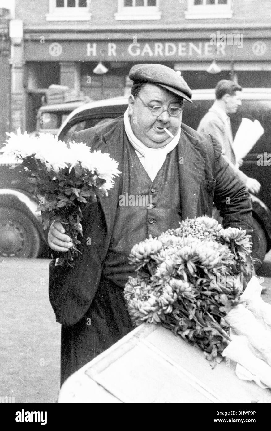 A London flower seller, Covent Garden Market, 1952. Artist Henry Grant