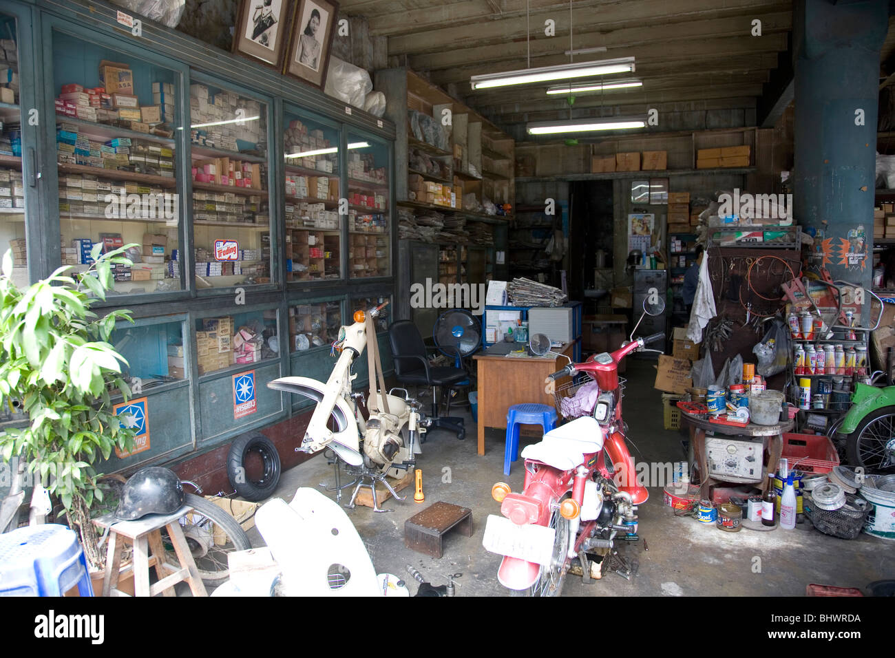 Busy interior of a shop -  fixing bikes and motorcycles in Phuket Stock Photo