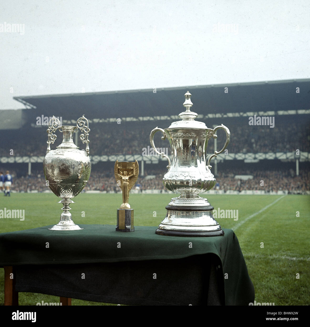 The League Championship trophy, The Jules Rimet World Cup trophy and the FA Cup trophy on display before the Liverpool v Stock Photo