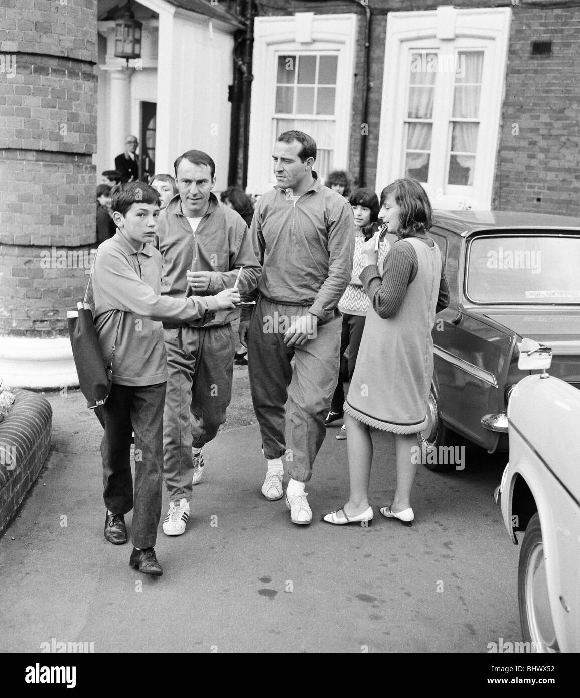 England team training during the World cup tournament in England. Jimmy Greaves signs autographs for young fans on the way to Stock Photo