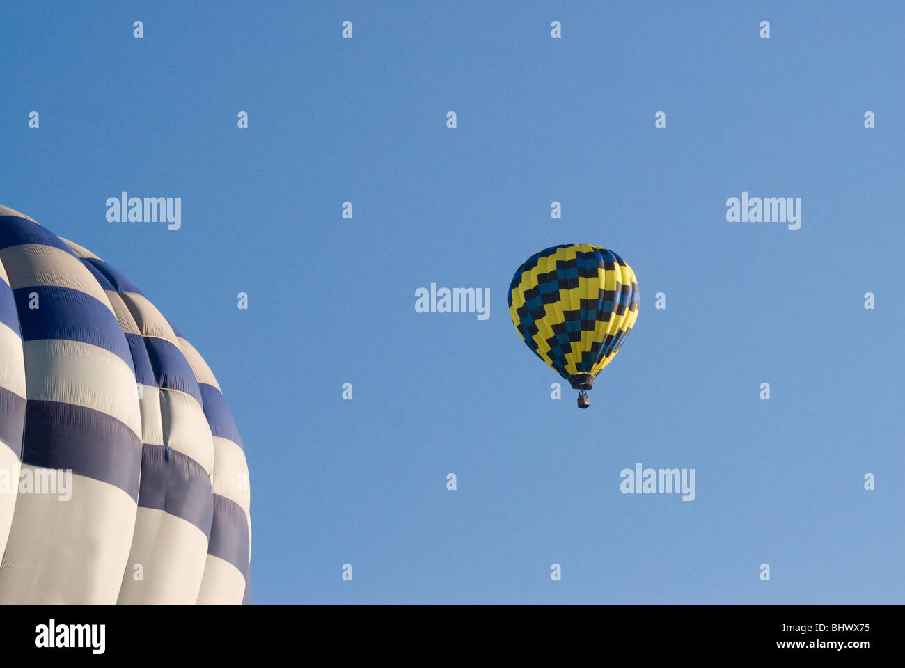 Colored Hot air balloons flying up in a clear blue sky Stock Photo - Alamy