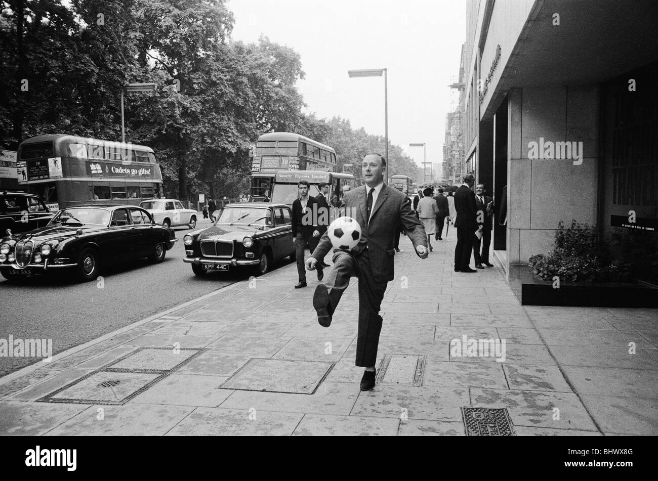 1966 World Cup Tournament in England. With a kick and header, Minister of Sport Dennis Howell opens the World Cup Information and Travel Centre at Reed House in readiness for the tournament. 5th July 1966. Stock Photo