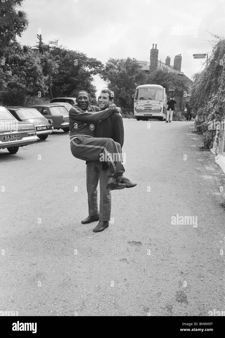 1966 World Cup Tournament in England. Injured footballer Gerson of Brazil, carries his teammate Santos to the team's hotel at Lymm for lunch. 15th July 1966. Stock Photo