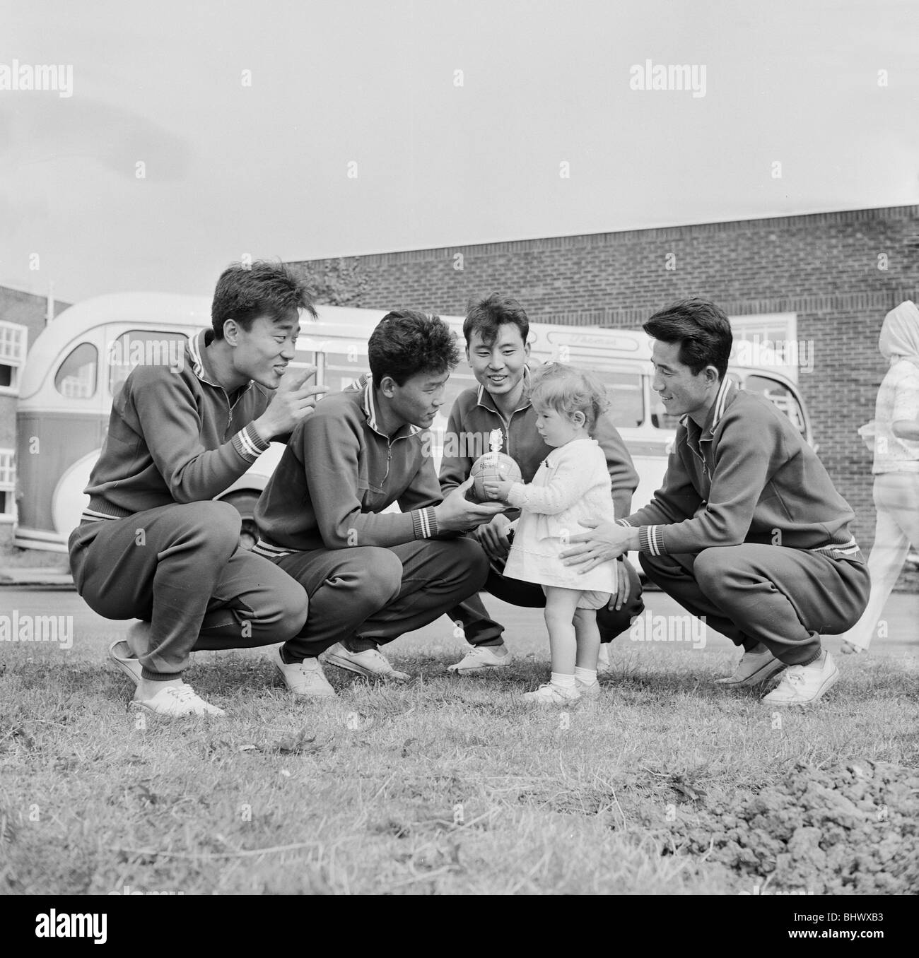 1966 World Cup Tournament in England. Young Elain Penman of Darlington presents a World Cup Willie tin of toffees for these North Korea footballers. They are left to right: Rim Joong sun, Li Chan Myung, Kim Yung Kil and kang Ryong Woon. 21st July 1966. Stock Photo