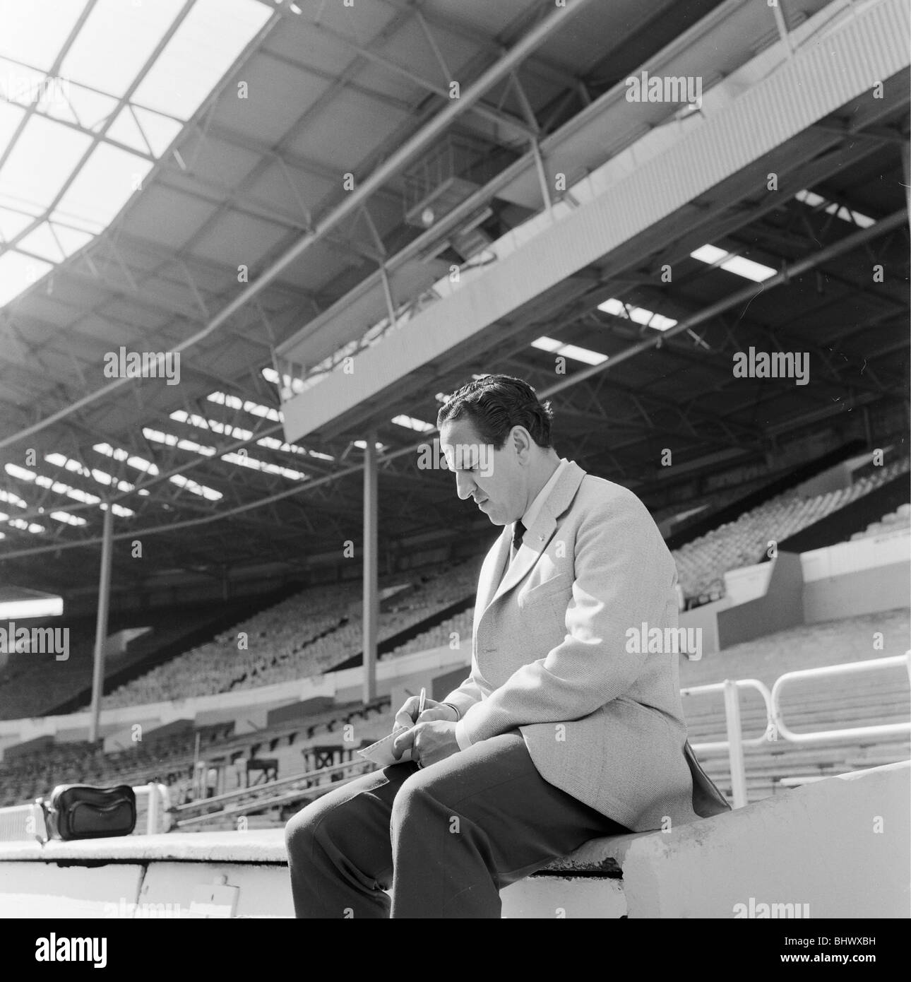 1966 World Cup Tournament in England. Team manager of Argentina Juan Carlos Lorenzo sits in the stand at Wembley making notes about the stadium for his team who weren't allowed to train there. 24th July 1966. Stock Photo