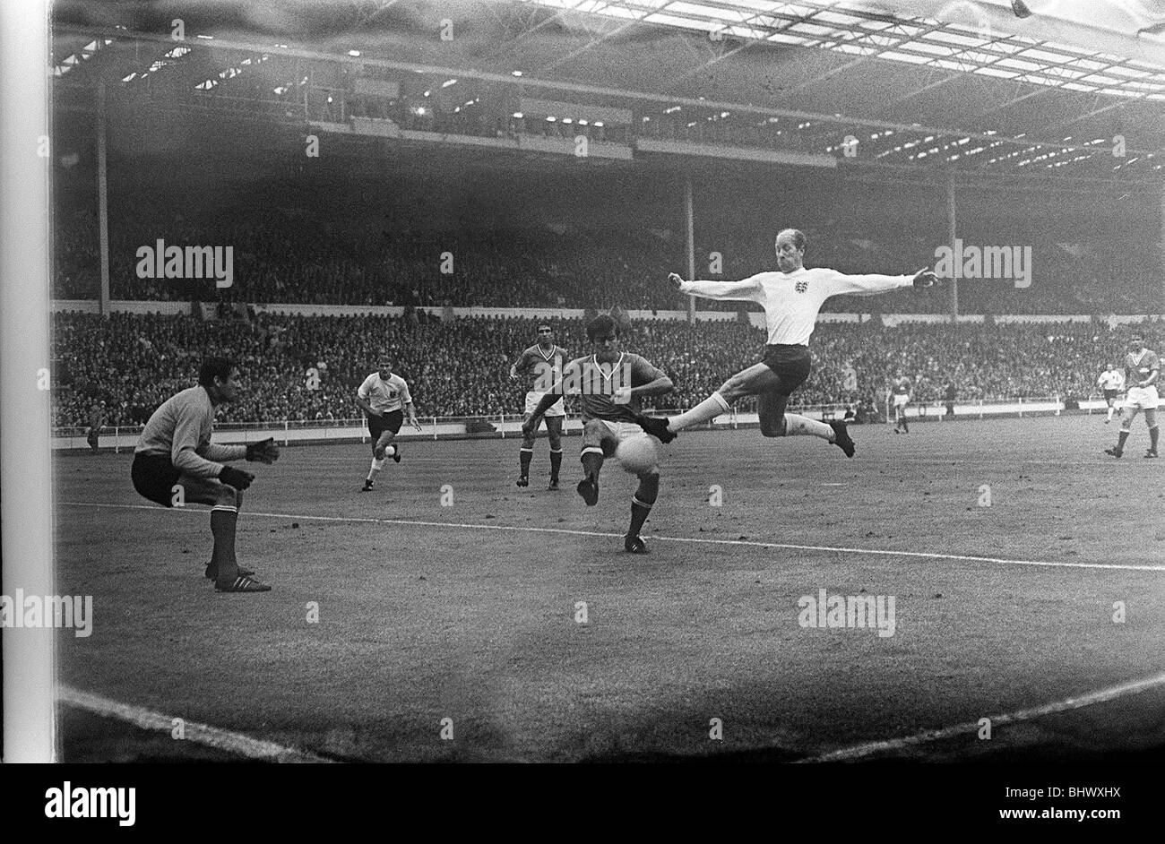 1966 World Cup Group One match at Wembley Stadium. England 2 v France 0. England's Bobby Charlton on fine form against the French defence as he leaps up to get a shot in at goal Stock Photo