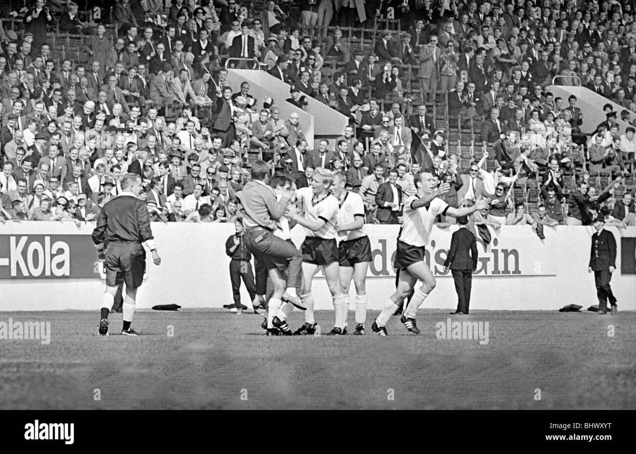 World Cup Quarter Finals West Germany versus Uruguay 24th July 1966 A West  Germany supporter runs onto the pitch to congratulate Seeler - number 19 -  after he scpred Germany's third goal