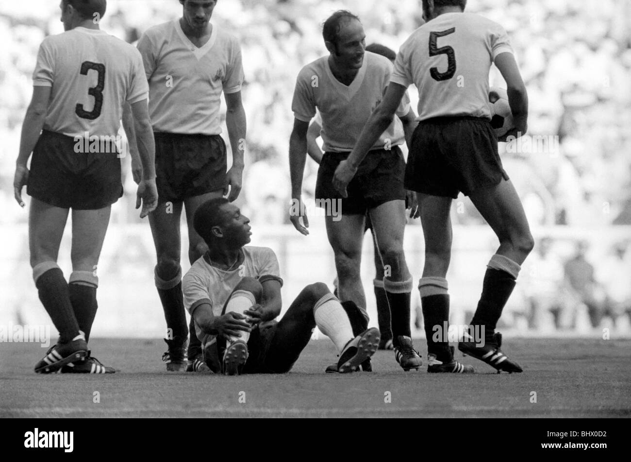 Brazil v. Uruguay: World Cup Semi-Final. Pele of Brazil on floor looks up at the Uruguan defenders after he had been blatantly Stock Photo