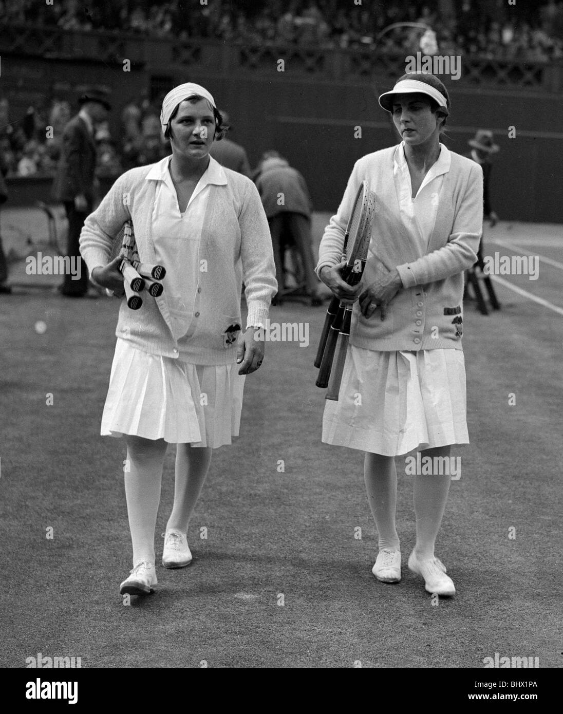 Helen Wills walks out on to the court at the Wimbledon tennis championships with her opponent Miss H Jacobs July 1929 Stock Photo