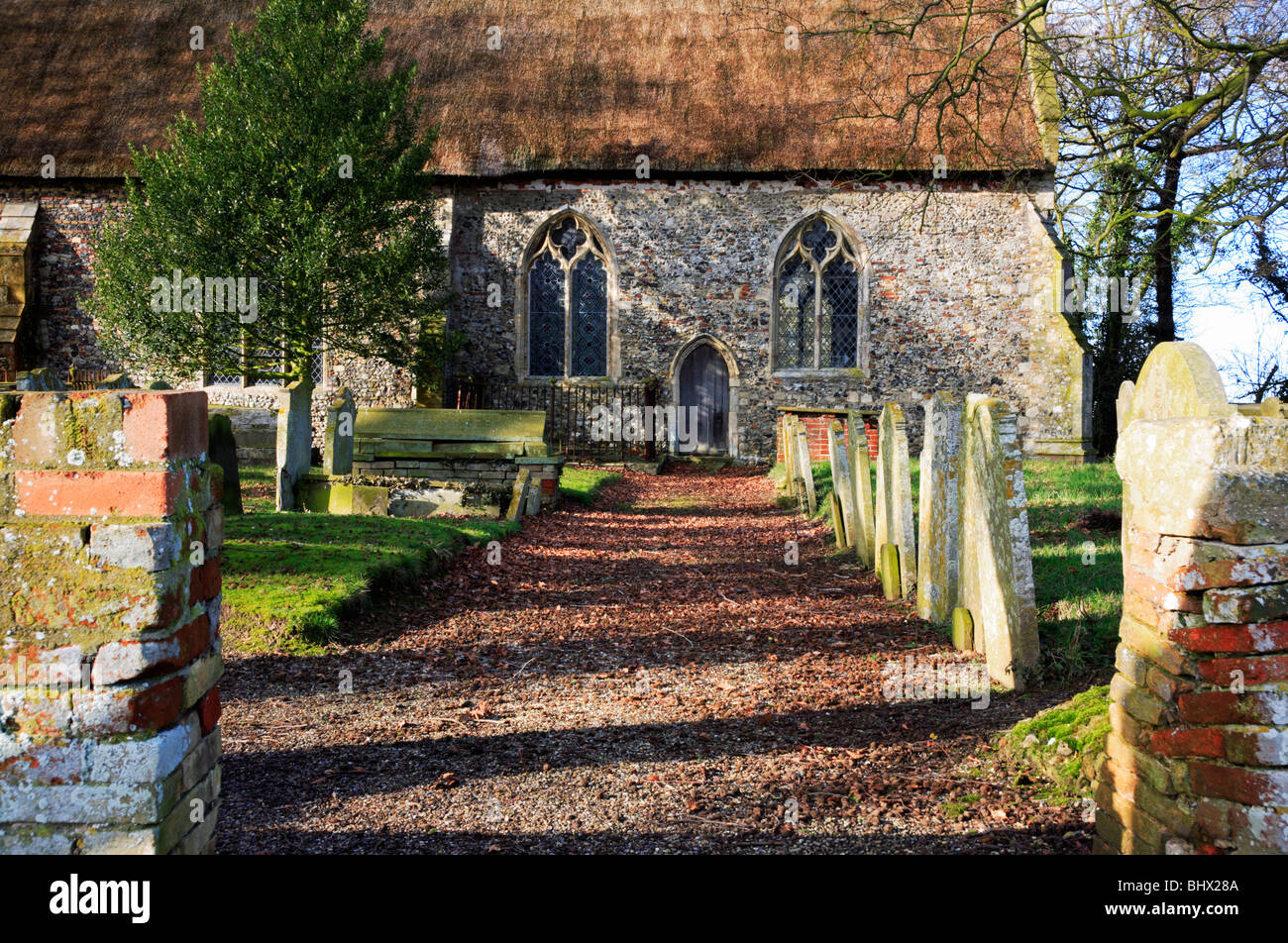 Path by gravestones leading to chancel door at the Church of Saint Andrew at Stokesby with Herringby, Norfolk, United Kingdom. Stock Photo