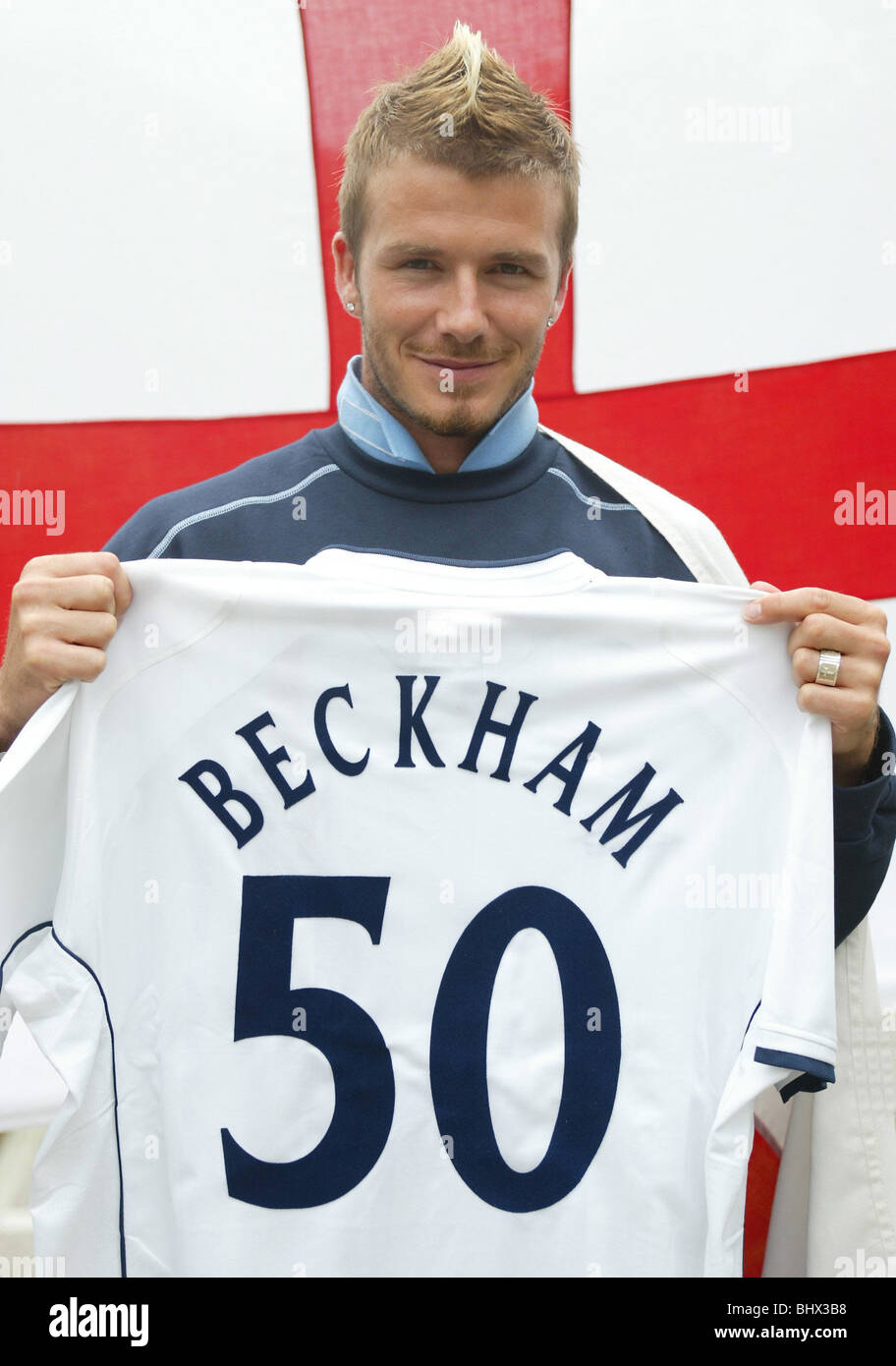 David Beckham, May 2002 The England football captain is photographed draped with the cross of St George on Awaji Island, Japan Holding up his 'Beckham 50' shirt Stock Photo