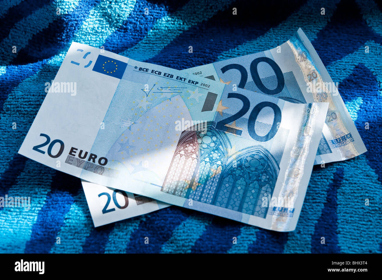 Euros on a colourful beach towel Stock Photo