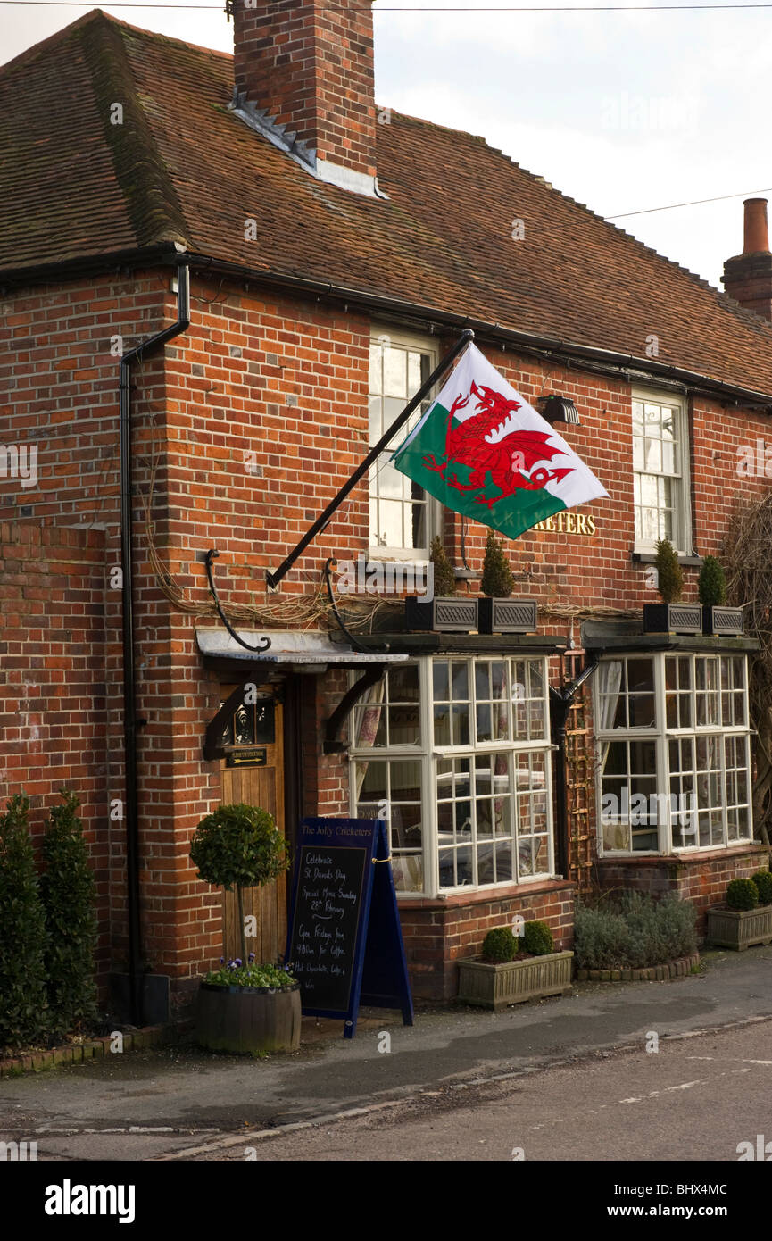 Jolly Cricketers local village pub in Seer Green  Buckinghamshire UK flying the Welsh national flag on St David's day. Stock Photo