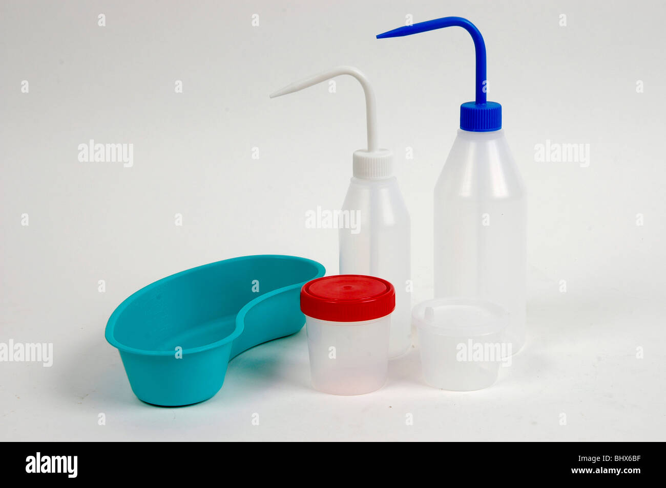plastic bottles with distilled water and kidney dish for cleaning Stock Photo