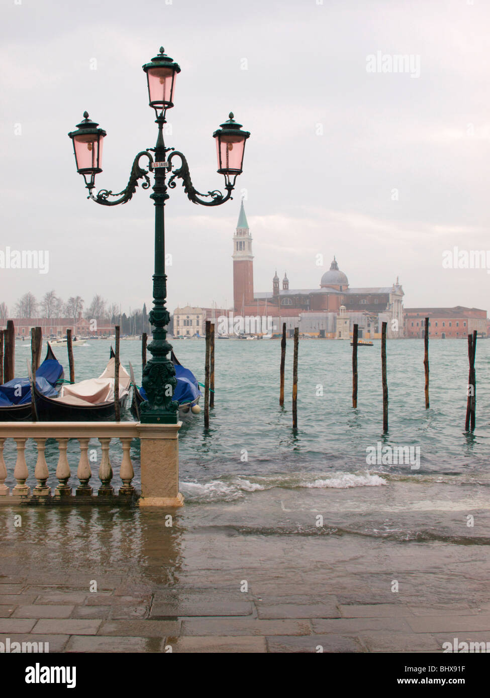 High tide in Venice, as water begins to flood into St Marks Square on a winters morning Stock Photo