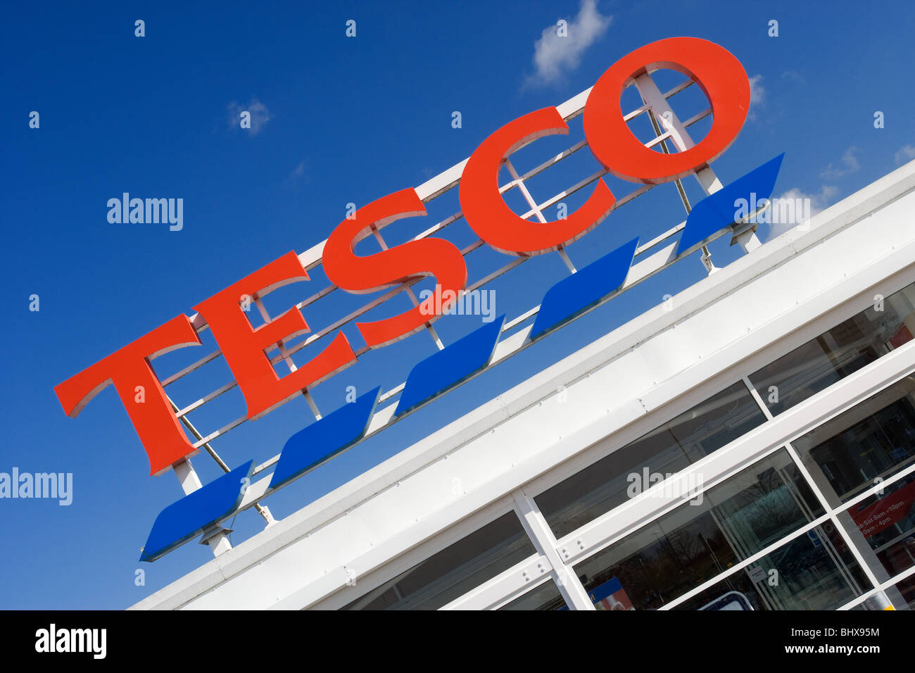 Tesco Supermarket Store Sign Against A Deep Blue Sky Stock Photo