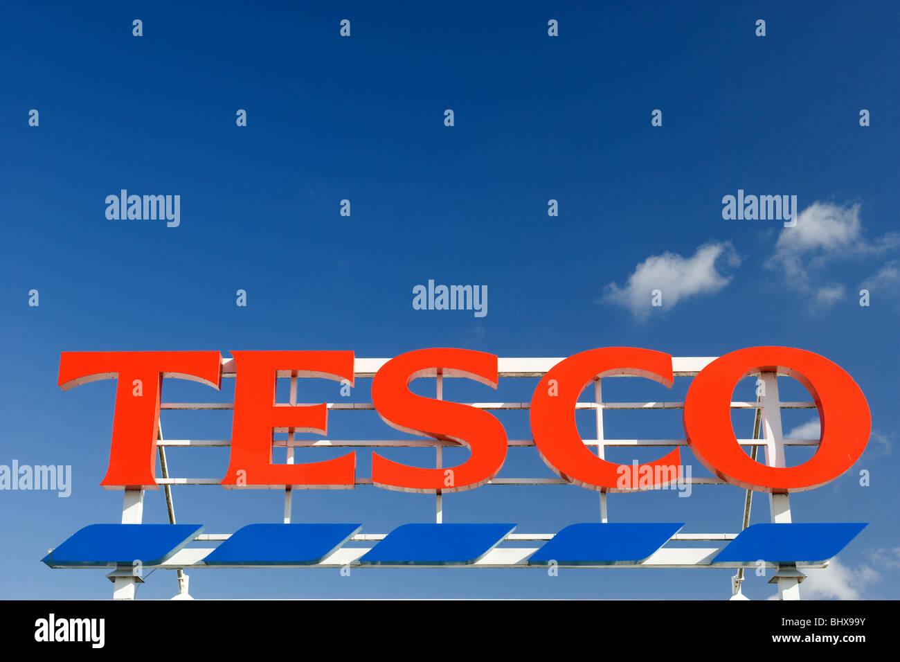 Tesco Supermarket Store Sign Against A Deep Blue Sky Stock Photo