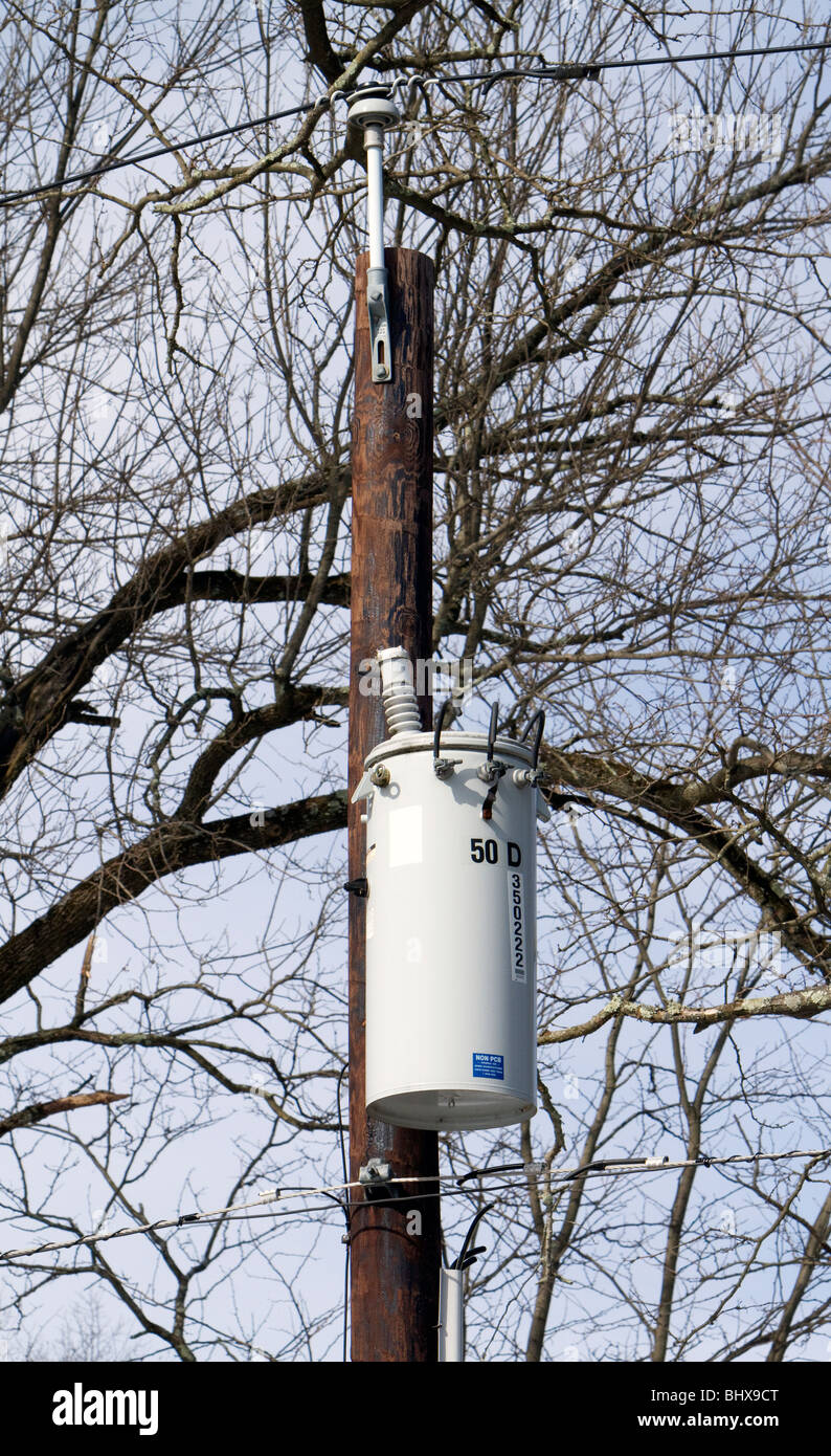 Electrical power transformer on a telephone pole. Stock Photo