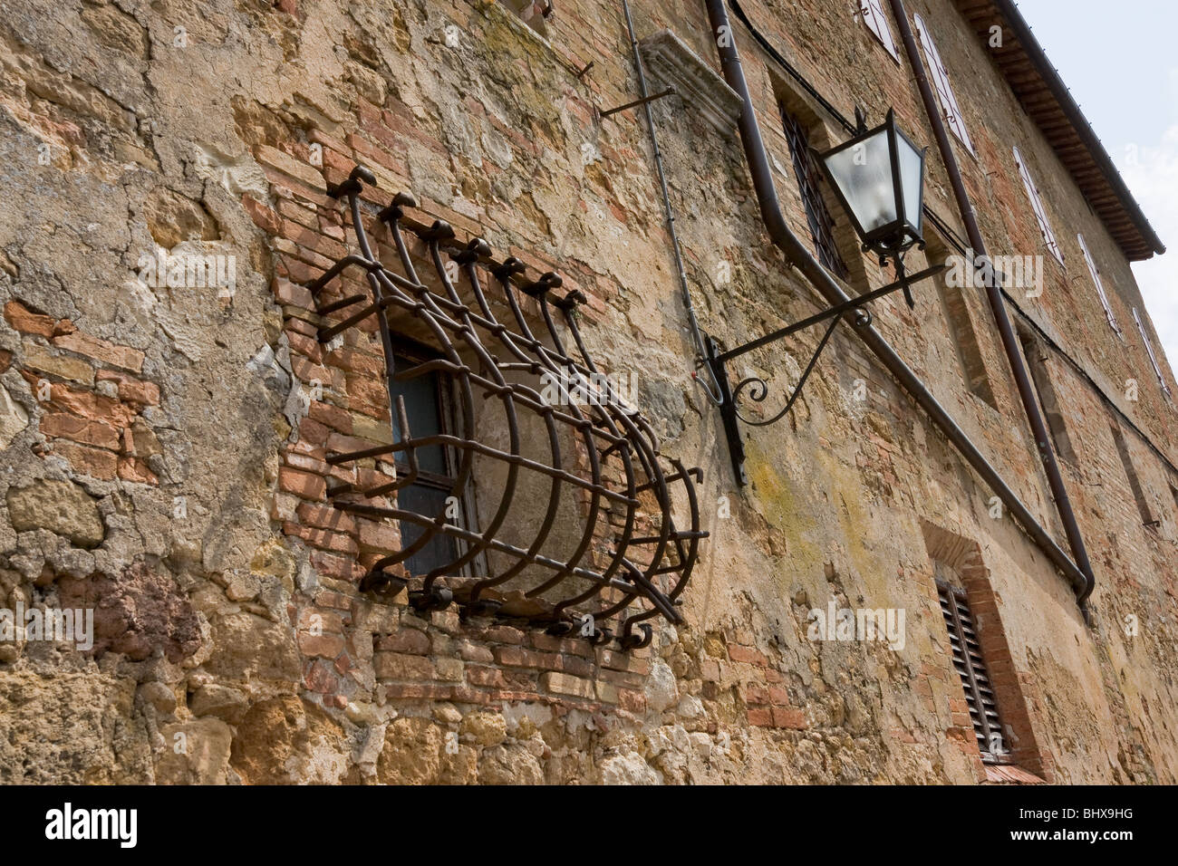 Small window with bars and lamp in Italian village Stock Photo - Alamy