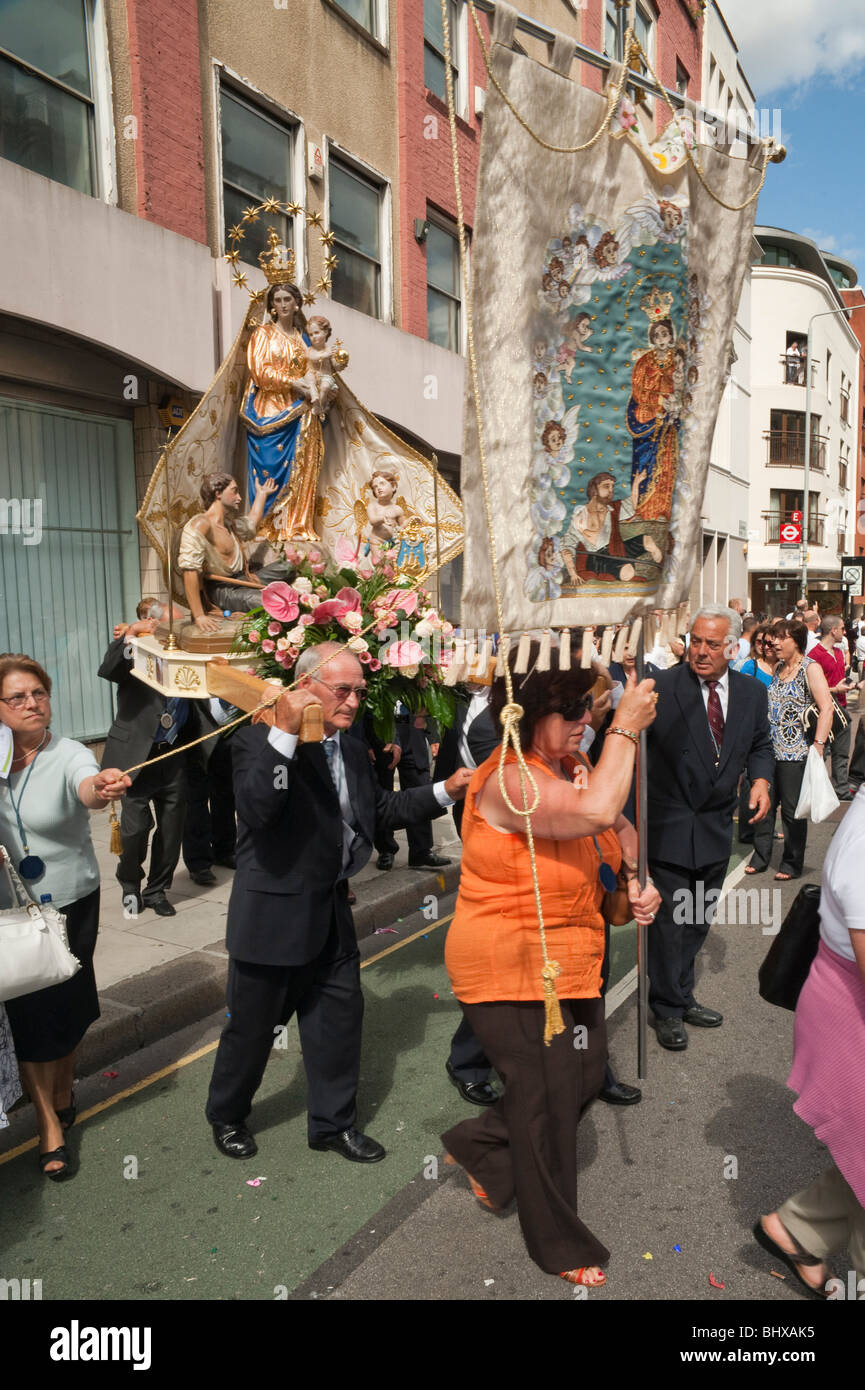 Procession Bearers Banner and statue carried on bearer's shoulders in procession in Honour ...