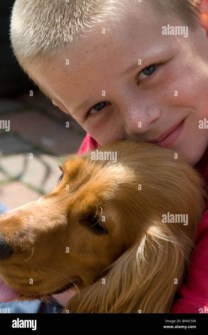 Boy and Dog in Garden Stock Photo