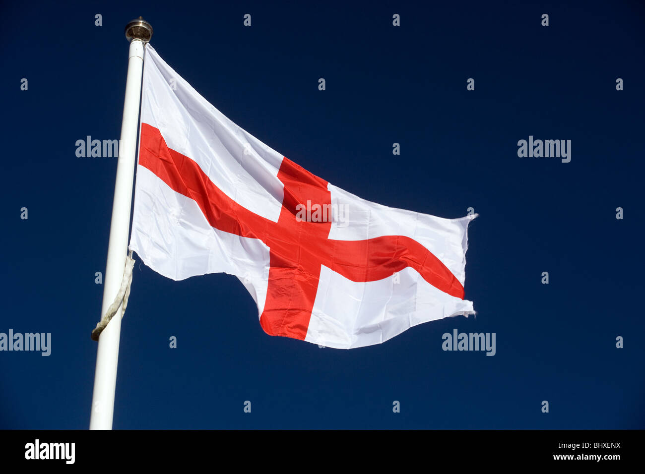 St George Flag On A Flag Pole Against A Deep Blue Sky Stock Photo