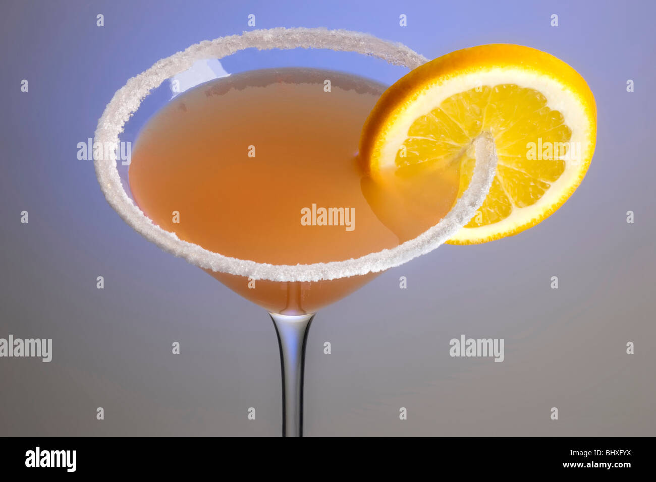 Sidecar mixed drink with orange garnish and sugar rim on plain background close up Stock Photo