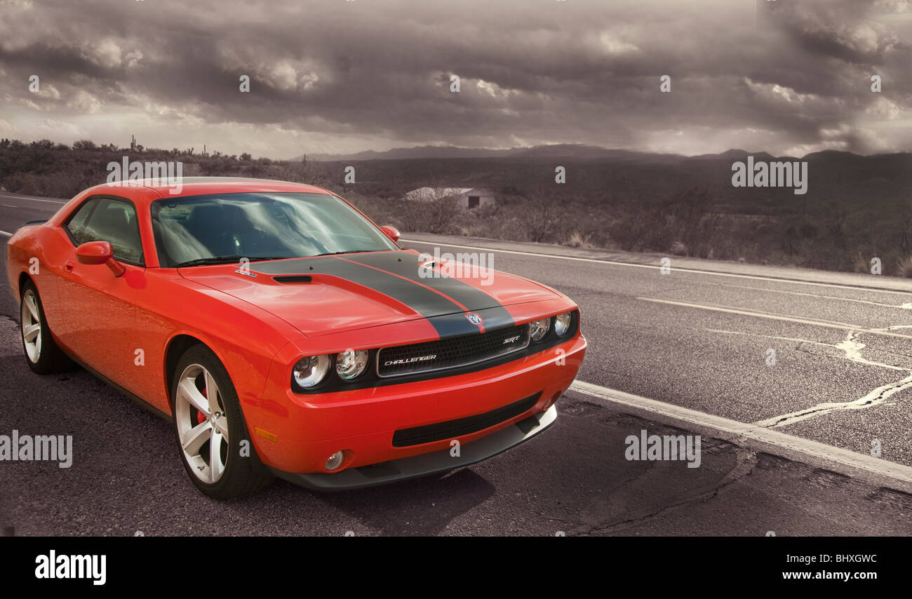 Orange muscle car on a stormy highway. Stock Photo