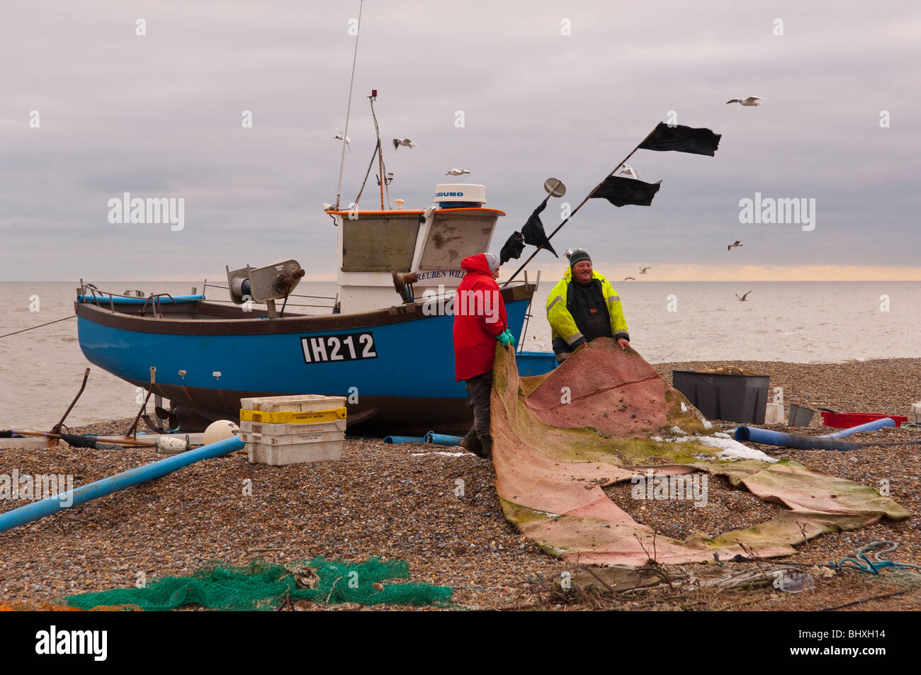 Two fishermen at work on the beach in Aldeburgh , Suffolk , England , Britain , Uk Stock Photo