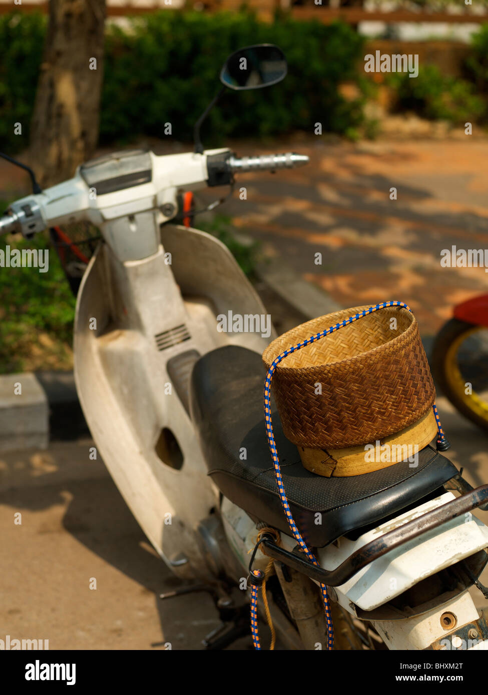 Motorbike with a sticky rice basket strapped to the back Stock Photo