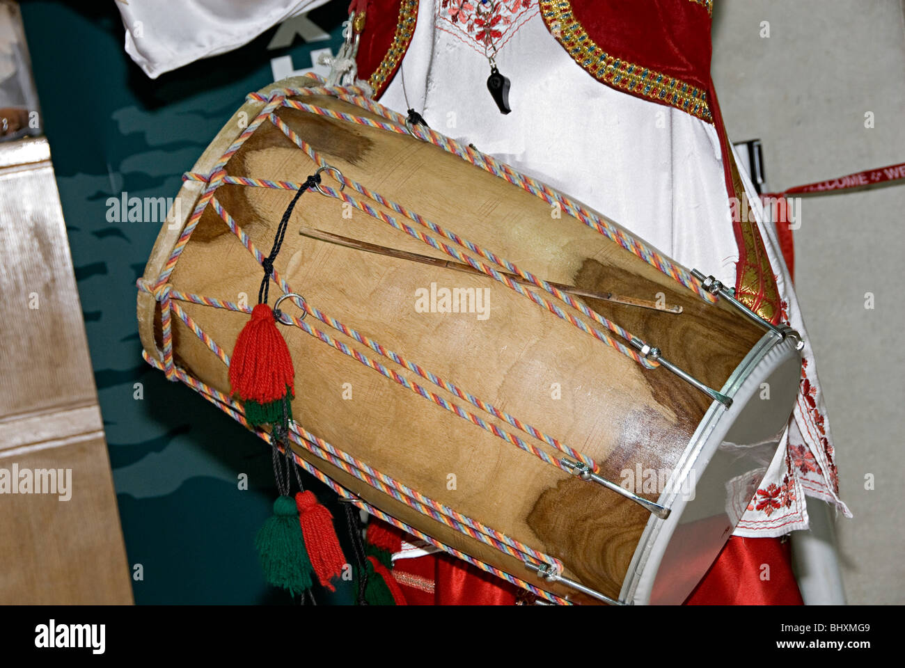 a dhol drum being banged at an opening ceremony by an asian man playing bhangra Stock Photo