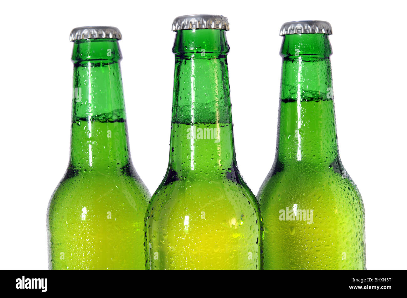 Three green beer bottles isolated on white background - Selective focus on front bottle Stock Photo