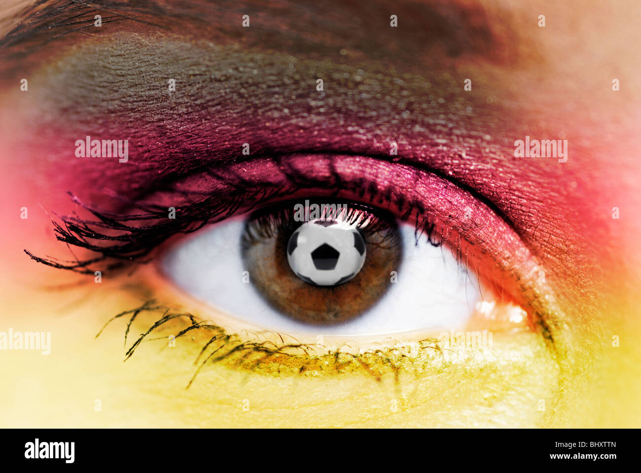 A soccer ball is reflected in the eye of a woman Stock Photo