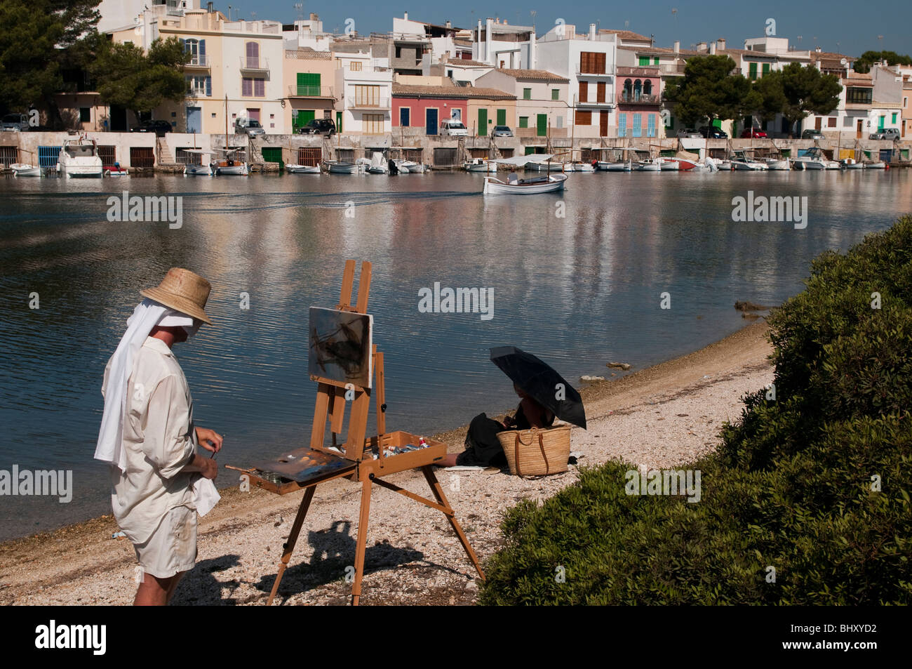 A painter at work with a model in the background a small fishing village Stock Photo